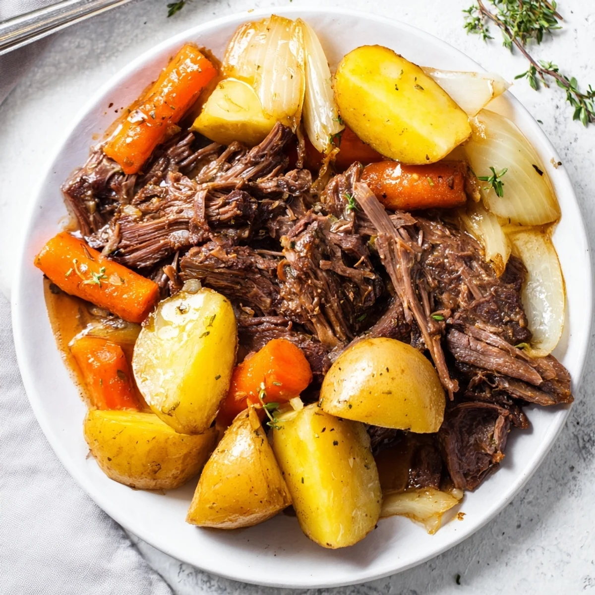 Golden Slow Cooker Pot Roast surrounded by herbs and vegetables, ready to serve hot.