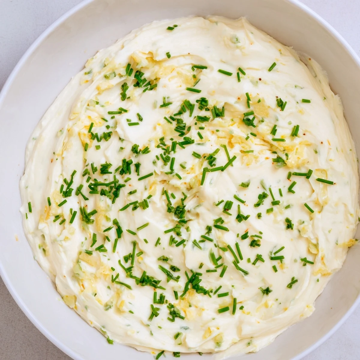 A bowl of homemade Creamy Snack Cheese Dip bubbling with cheddar and mozzarella, ready for a game day appetizer spread.