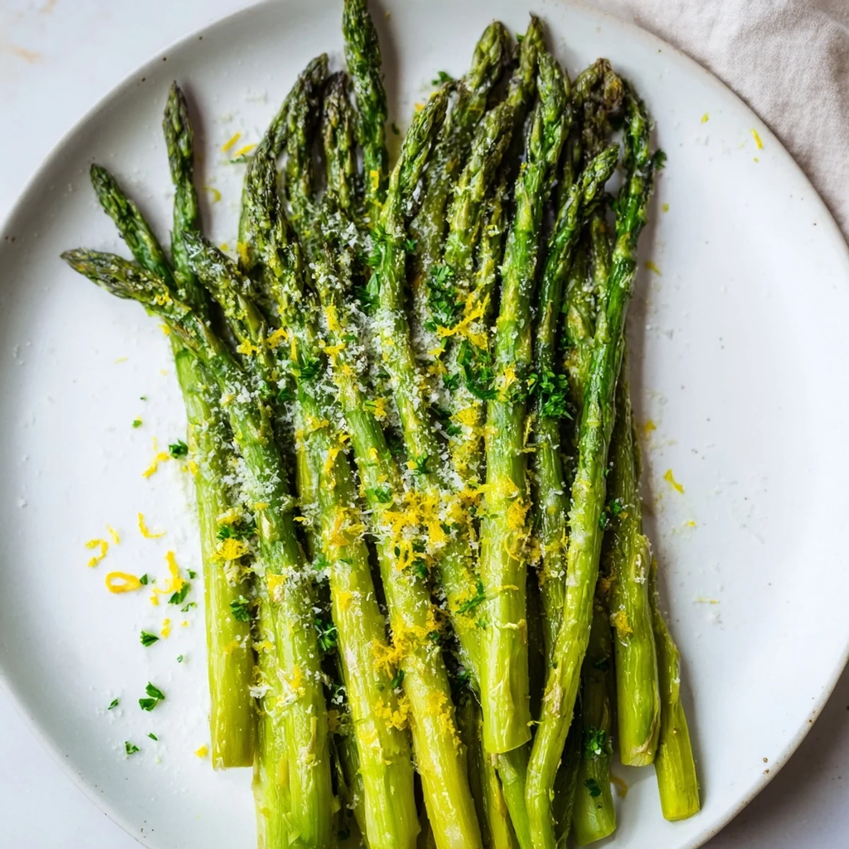 Roasted Asparagus with Parmesan and Lemon garnished on a serving platter, ready to enjoy as a simple Mediterranean side dish.