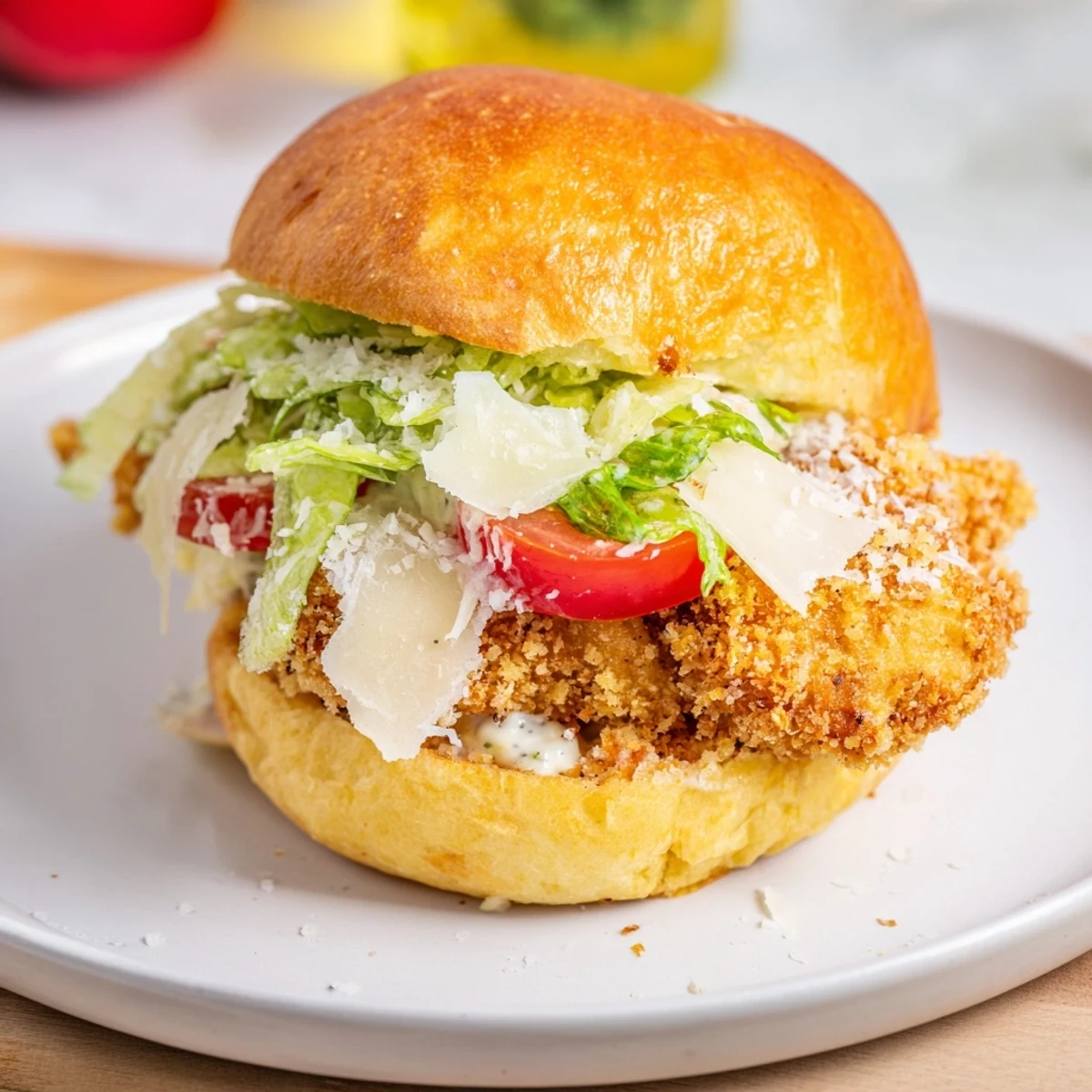 The Marry Me Crispy Chicken Caesar Sandwich stacked high with fresh romaine lettuce and creamy dressing, ready to be eaten.