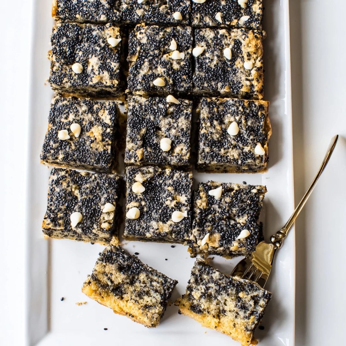 Warm, chewy Black Sesame Blondies topped with whole sesame seeds and a hint of white chocolate.