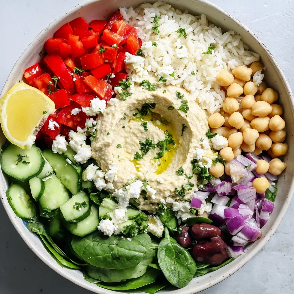 Healthy Mediterranean rice bowl arranged with fluffy rice, spinach, tomatoes, and protein-rich chickpeas
