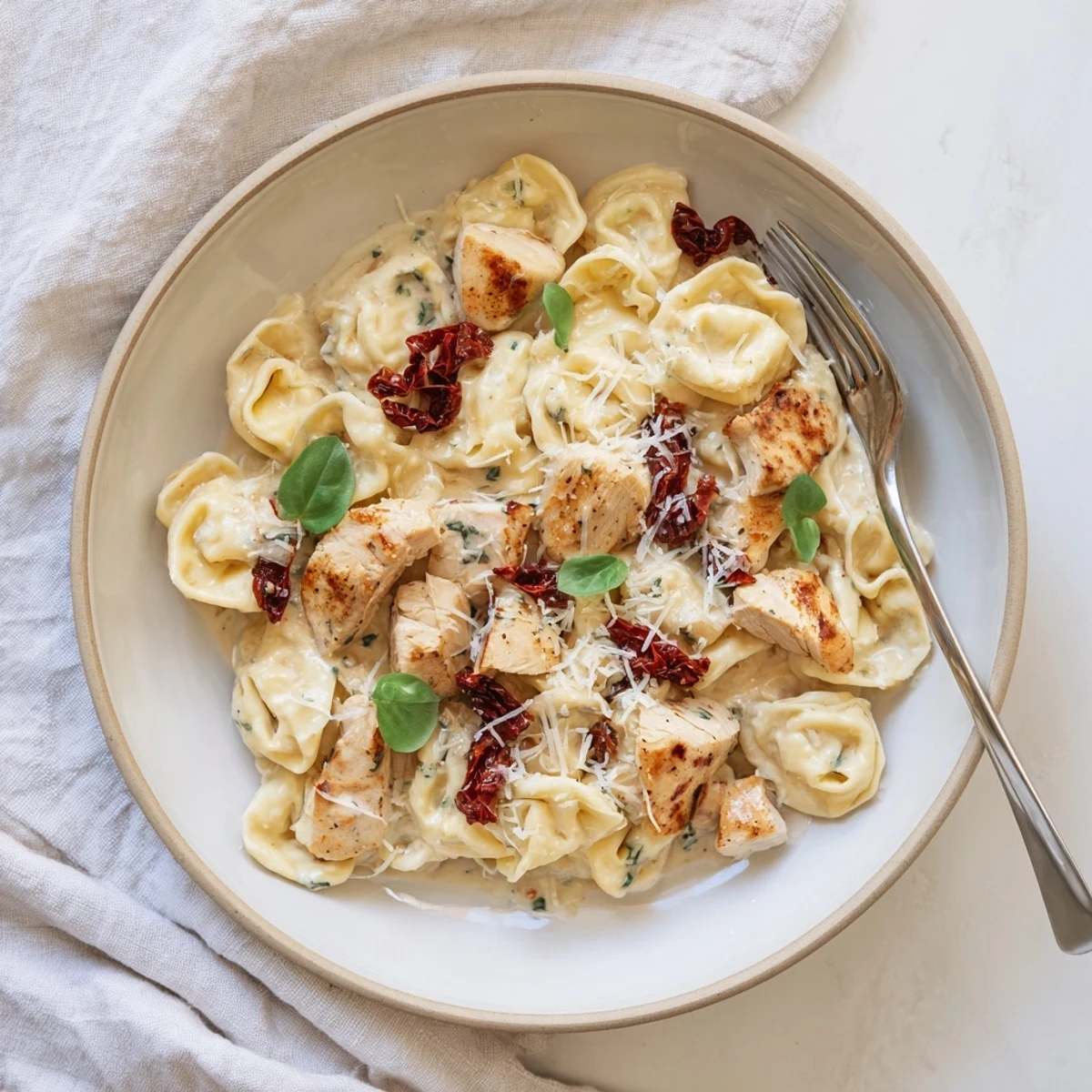 Creamy Marry Me Chicken Tortellini Skillet featuring golden chicken and sun-dried tomato parmesan sauce