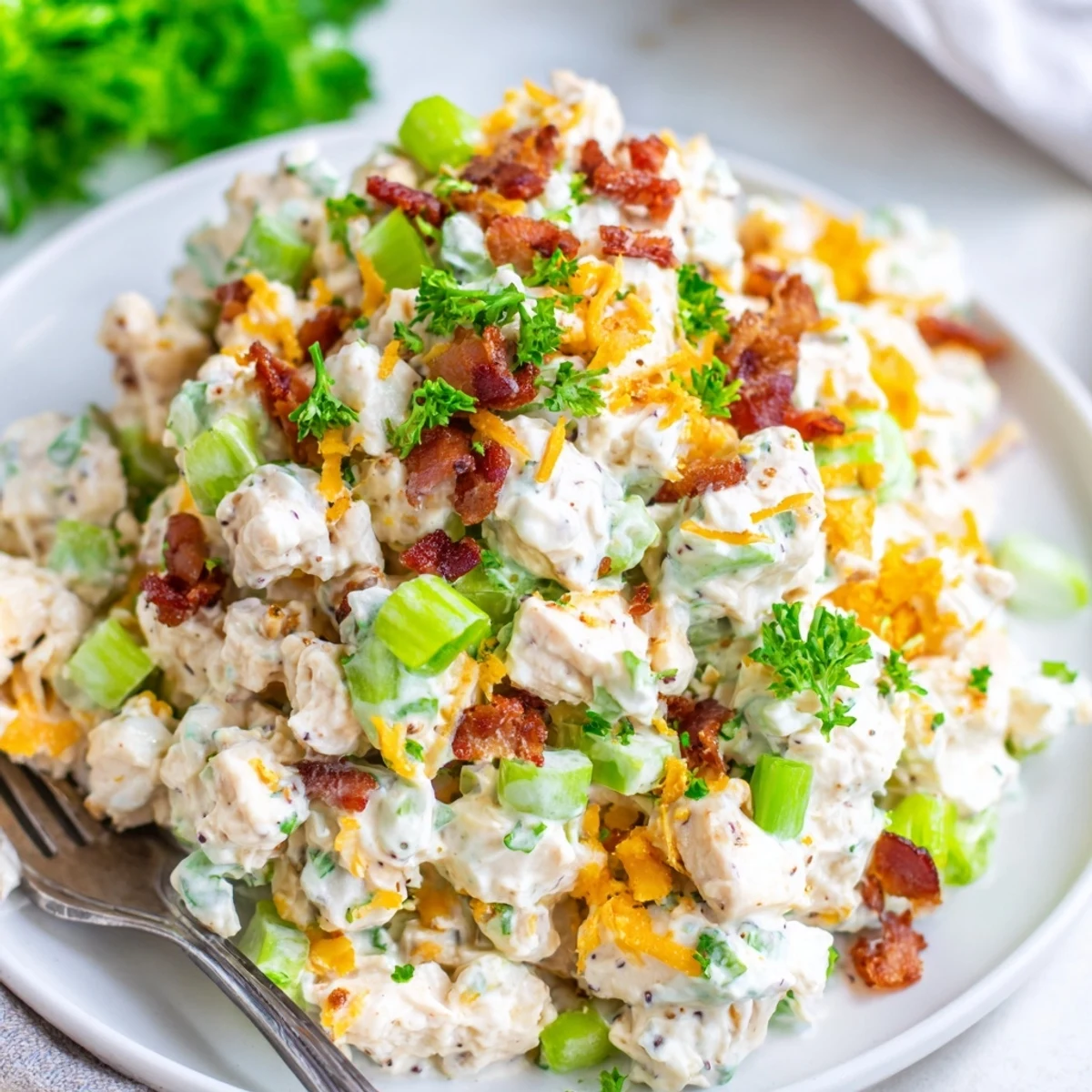 High protein low carb jalapeno popper cottage cheese chicken salad served in lettuce wraps with bacon bits and sliced jalapeno peppers garnish