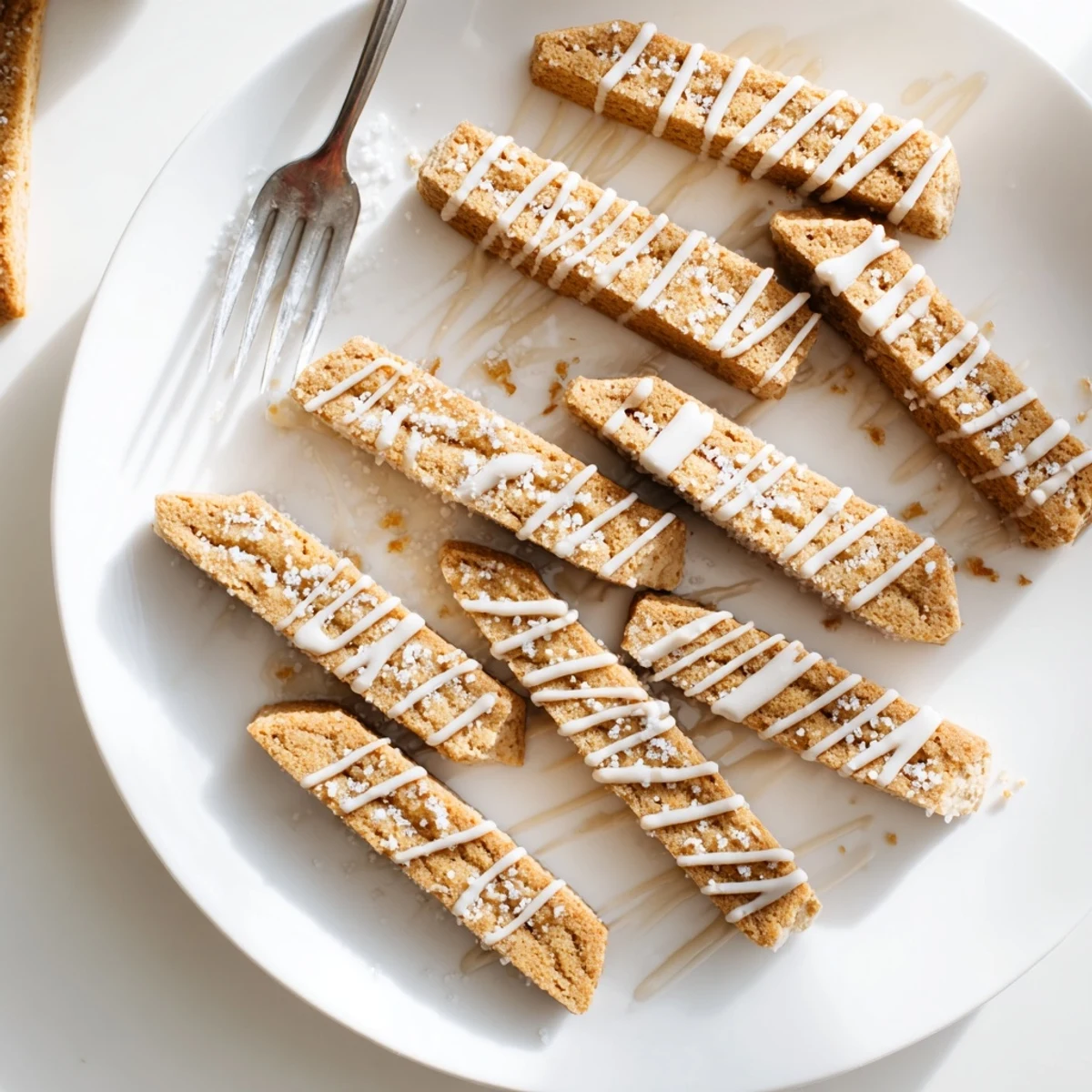 Crisp Italian-American sugar cookie biscotti dipped in coffee beside a teacup saucer