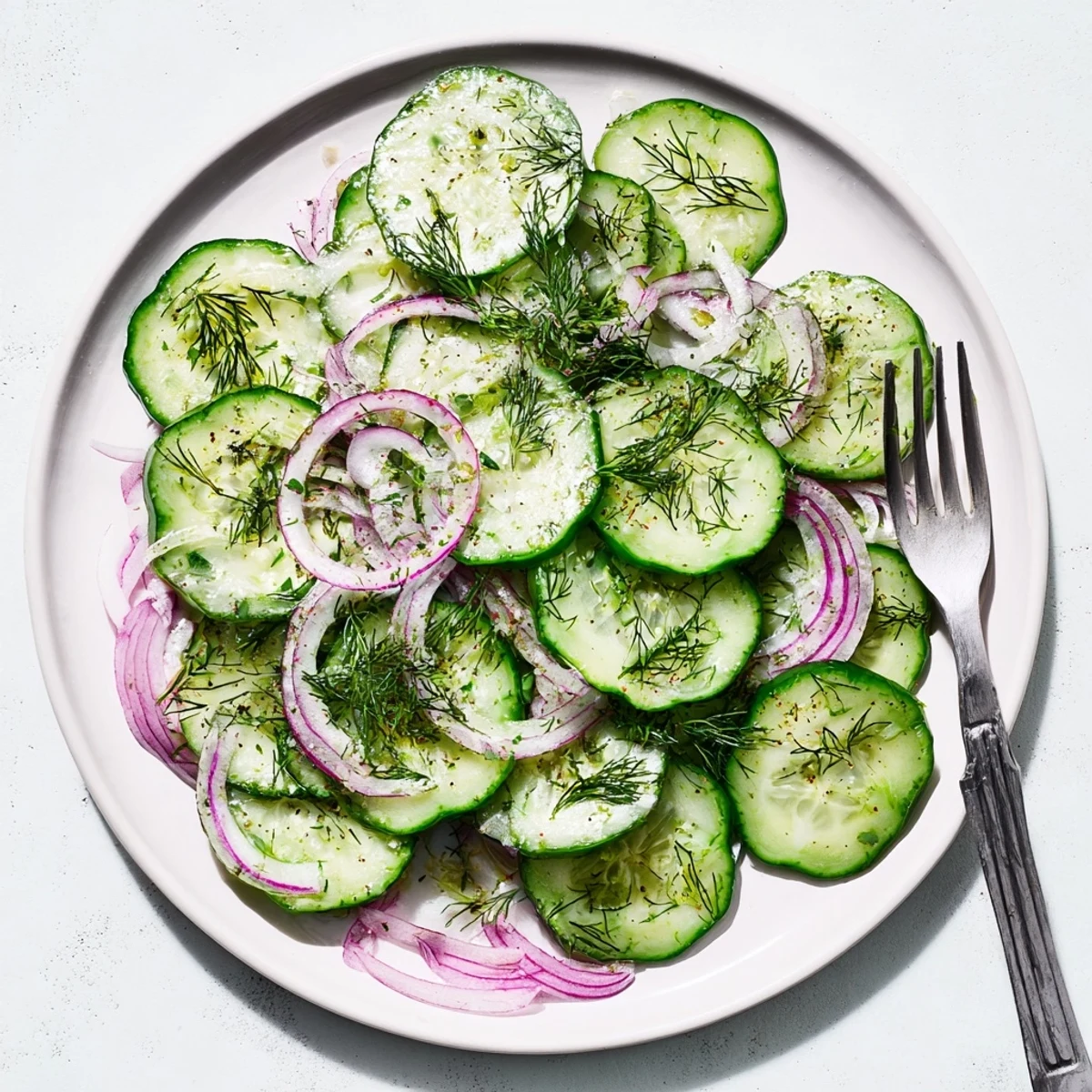 Easy refreshing cucumber salad featuring crisp vegetables in a sweet and tangy dressing