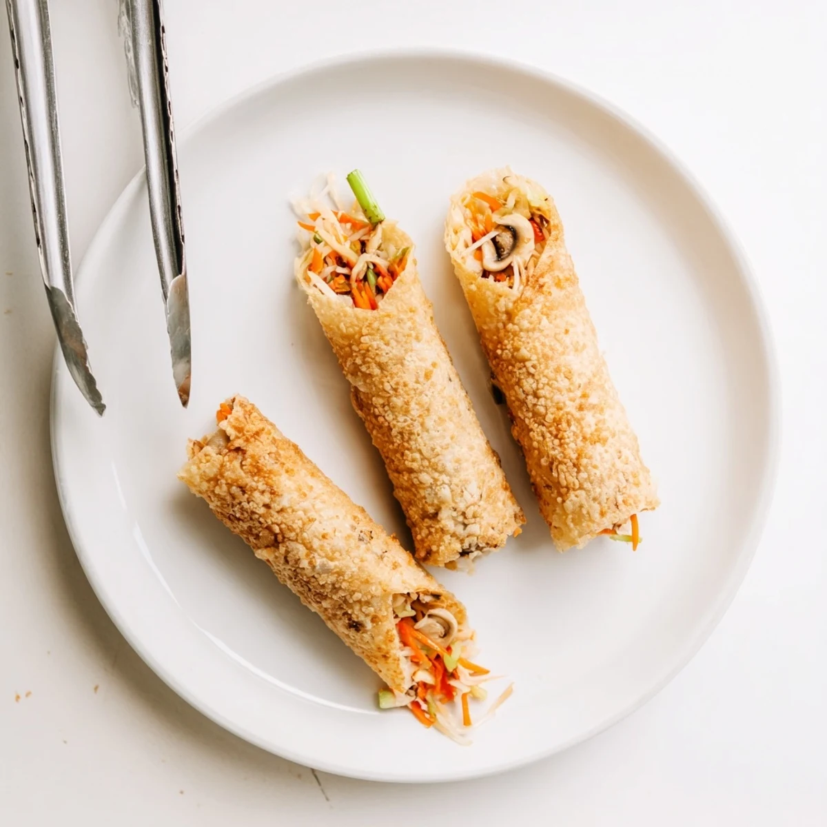 Vegan fried rice paper spring rolls with colorful vegetable filling plated for appetizer presentation