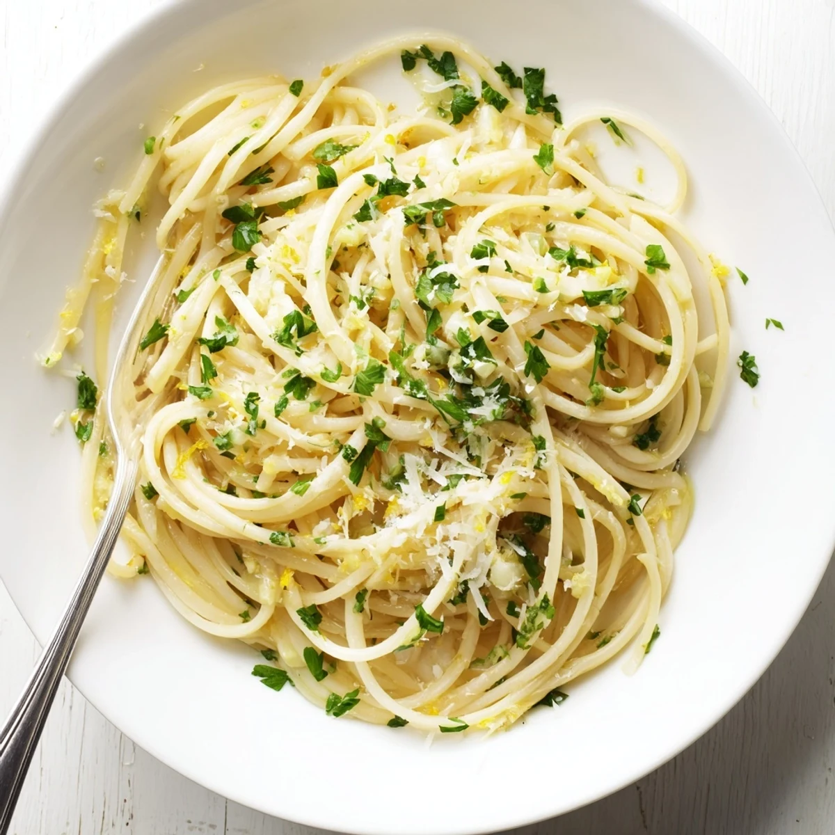 Twirled forkful of garlic butter pasta coated in rich savory sauce