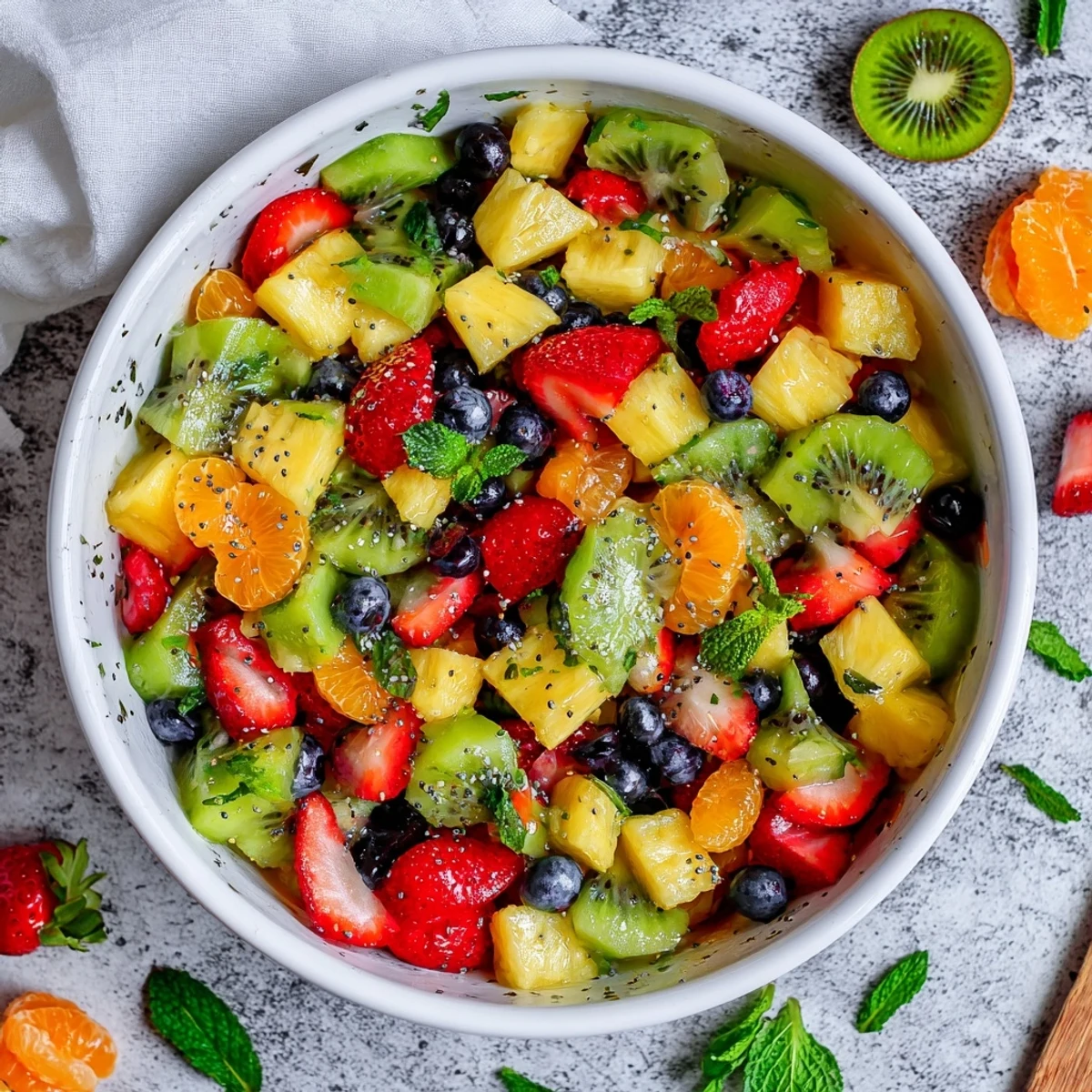 Festive Easter fruit salad displaying juicy strawberries, grapes, and tropical pineapple in a light citrus honey dressing