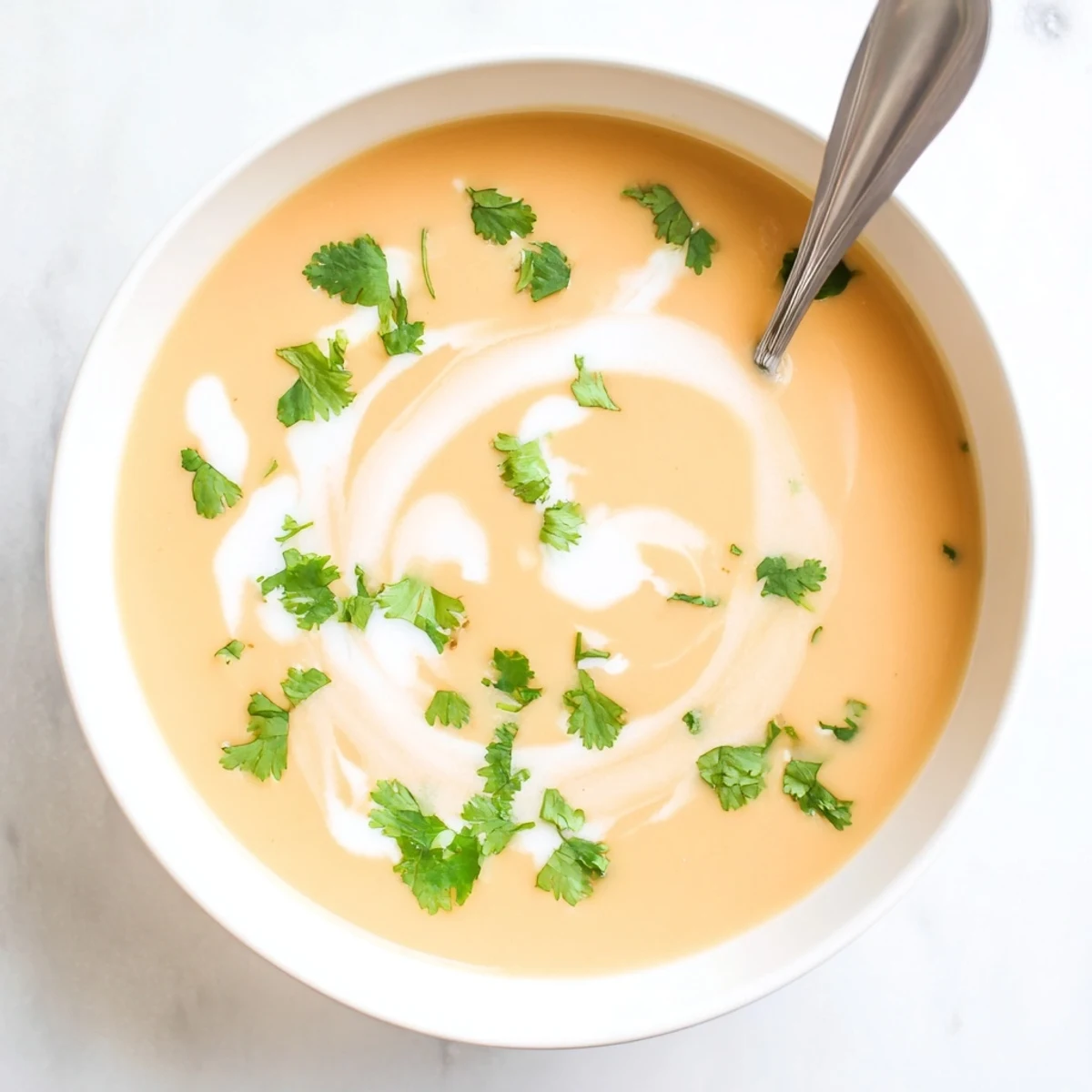 Homemade spicy apple soup recipe served hot with crusty bread and fresh herb garnish