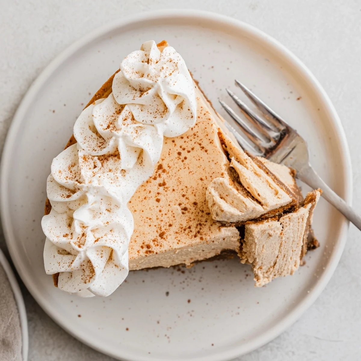 Creamy pumpkin dessert on graham cracker crust garnished for Christmas celebrations