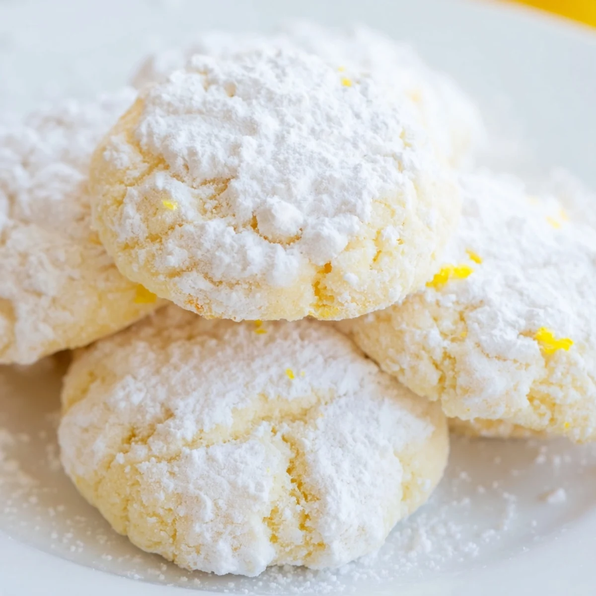 Golden buttery Lemon Meltaways stacked on a wire cooling rack after baking