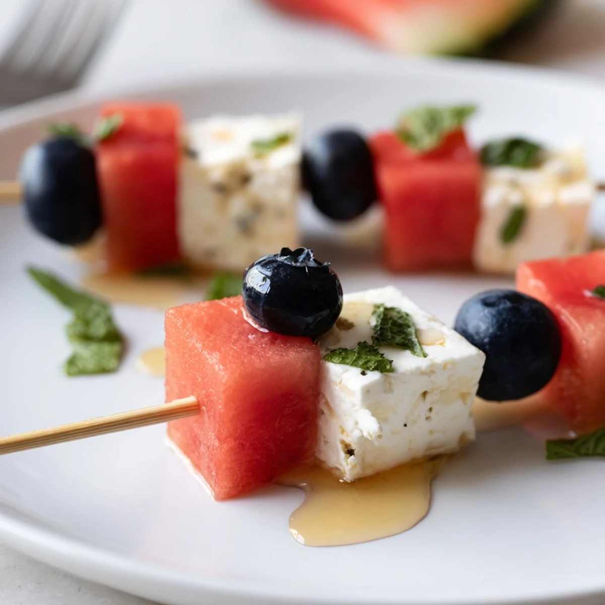Chilled Patriotic Watermelon Feta Skewers drizzled with honey and fresh mint