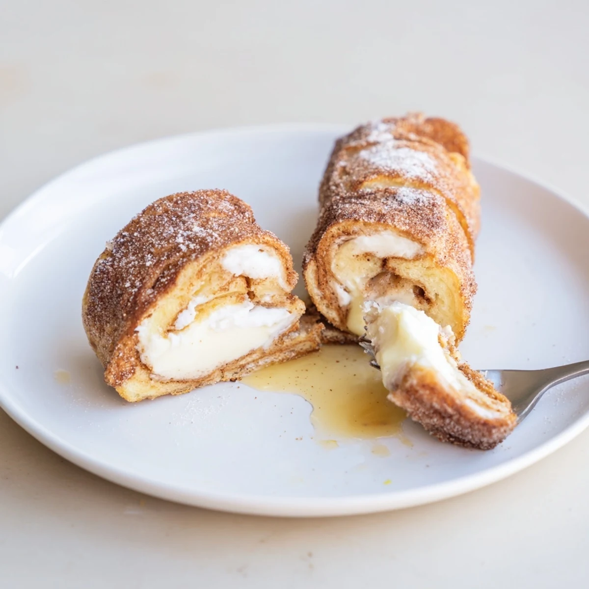Warm Cinnamon Roll French Toast Roll Ups filled with sweet cream cheese  