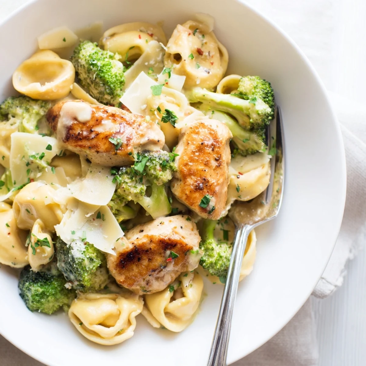 Creamy Garlic Parmesan Tortellini Chicken Broccoli Recipe tossed in silky sauce with golden chicken.  