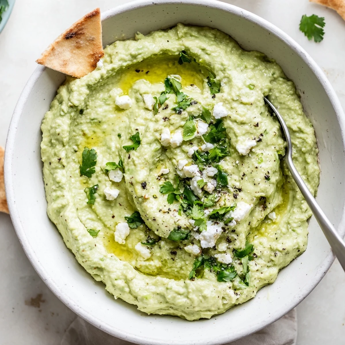 Homemade Creamy Avocado Feta Dip served with warm pita chips, bright lime