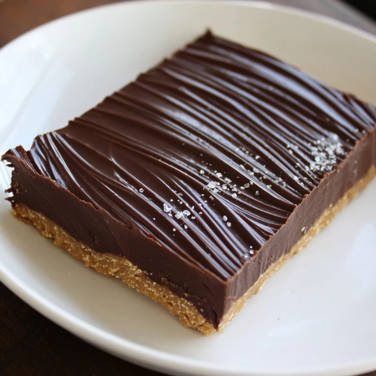 No Bake Peanut Butter Bars chilled on parchment, silky chocolate topping, nutty aroma.