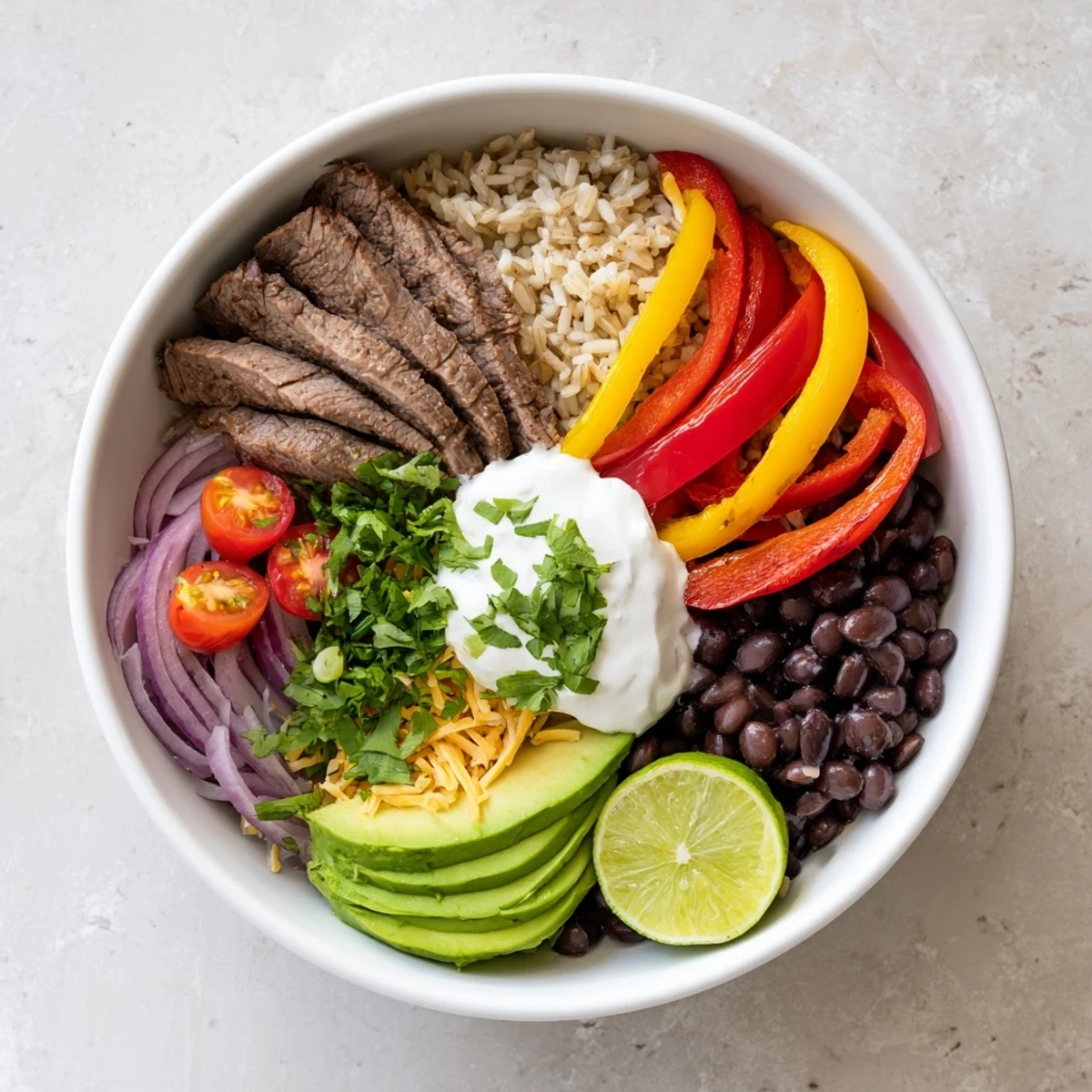 Steak Fajita Power Bowls topped with smoky seared steak, melting cheddar, cilantro.