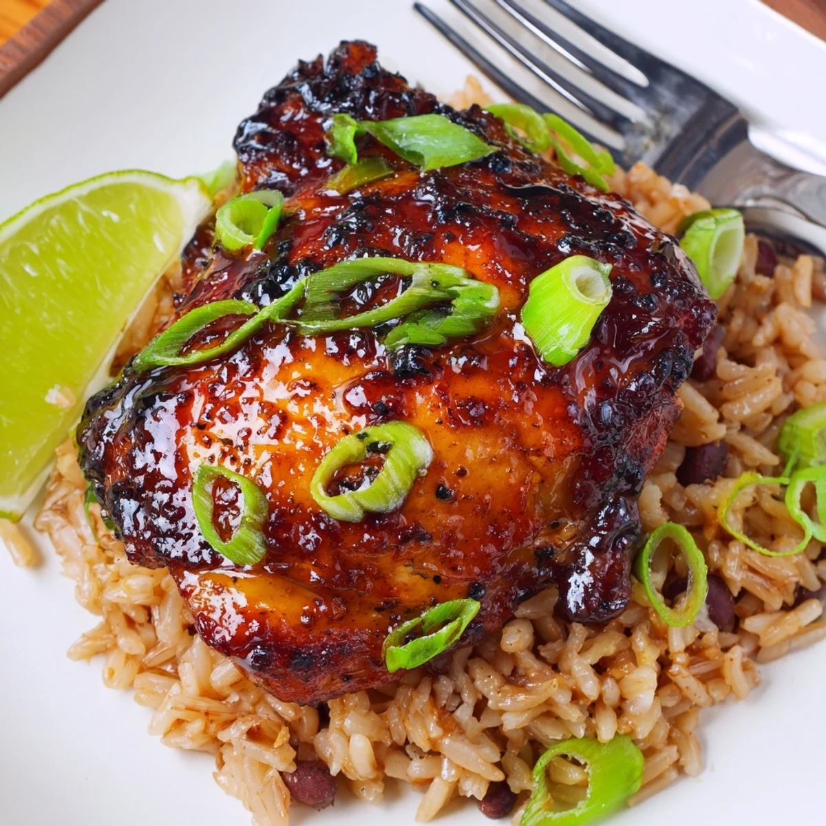 Grilled Caribbean Jerk Chicken And Rice with spicy Scotch bonnet glaze and lime.