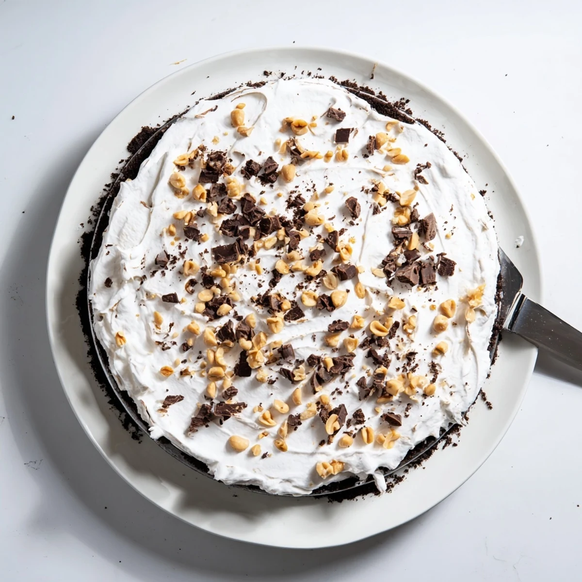 Creamy Peanut Butter Layered Delight with rich chocolate ganache in a glass dish