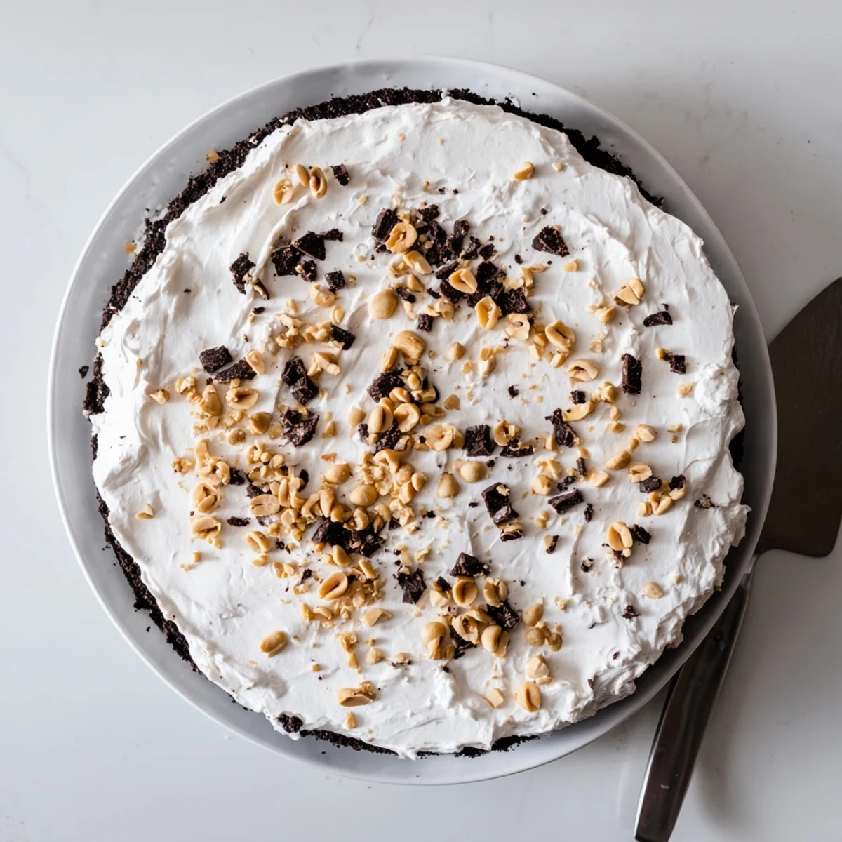 Golden peanut topping crowns this chilled no-bake Peanut Butter Layered Delight dessert