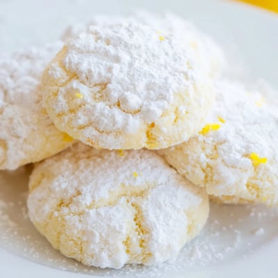 Golden buttery Lemon Meltaways stacked on a wire cooling rack after baking